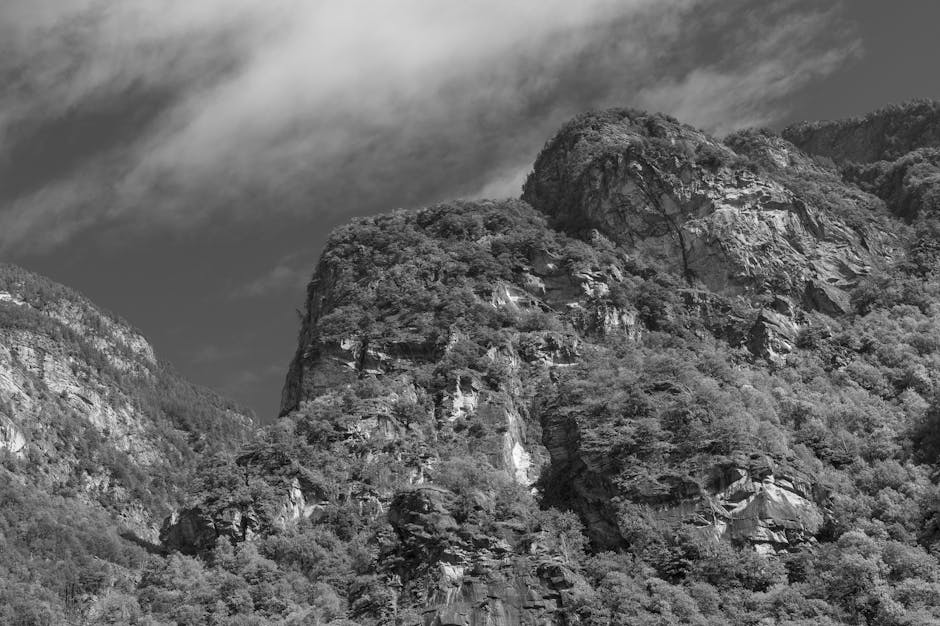 Dramatic grayscale mountain landscape under stormy clouds